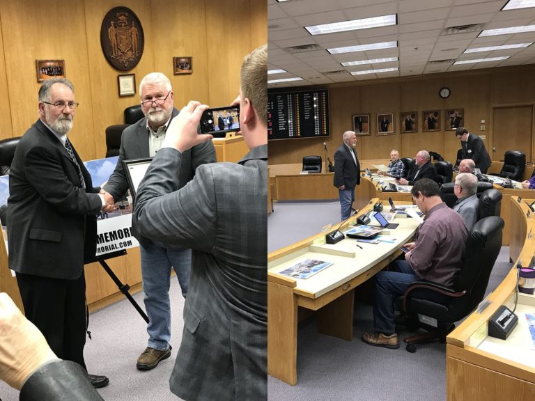 Gordon Haberman and County Board Chairperson Kriefall shake hands after passing the Washington County resolution