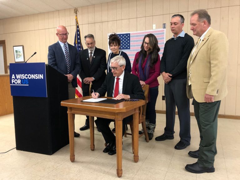 Governor Tony Evers signing the Wisconsin 9/11 Memorial Highway Bill into law