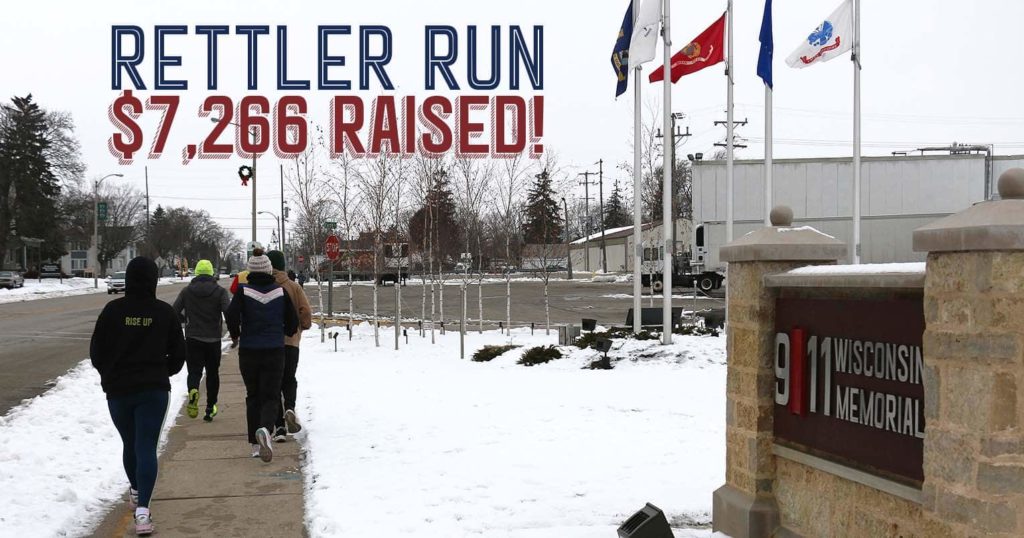 Four people running down the sidewalk in front of the Memorial with the words "Rettler Run" and "$7,266 raised!"