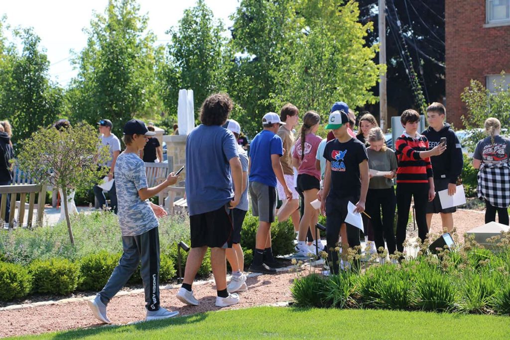 A group of middle schoolers completing a field trip activity