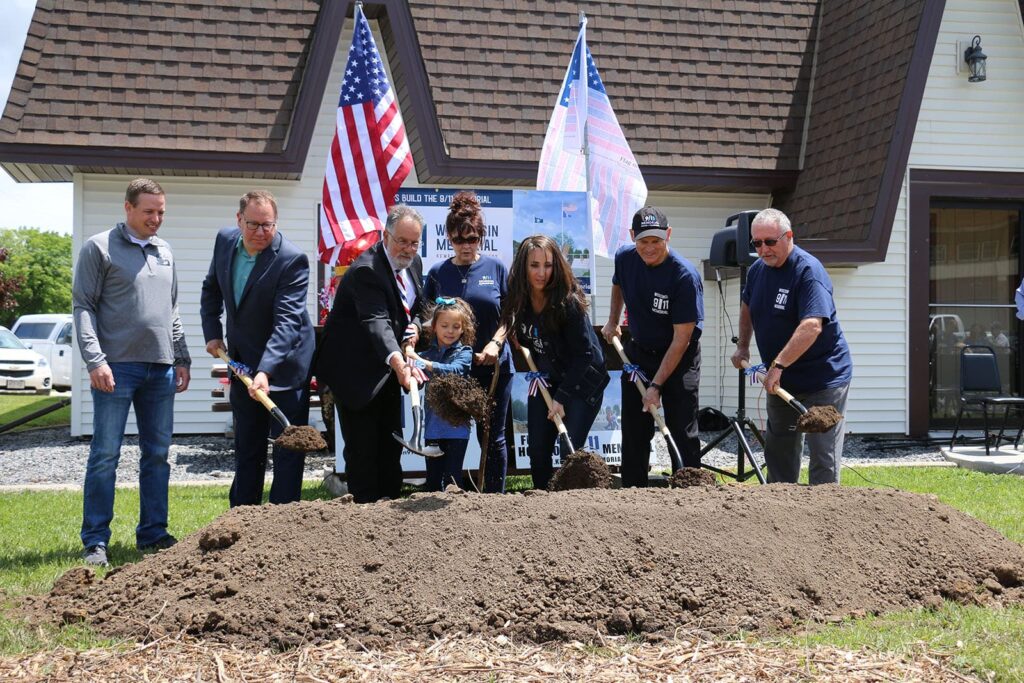 Groundbreaking ceremony at the Wisconsin 9/11 Memorial. Group of family and board members shoveling dirt. Jerry Gosa is pictured second from the right.