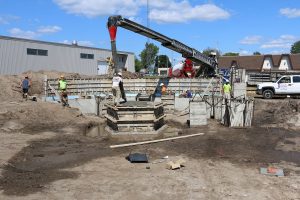 A concrete worker guides concrete into the form.