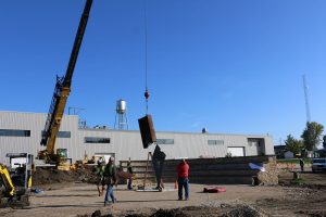 Crane lowering beam into the support