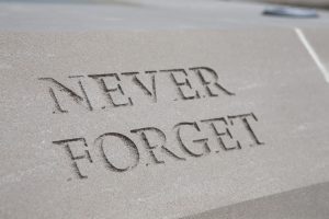 Concrete etched with "Never Forget"