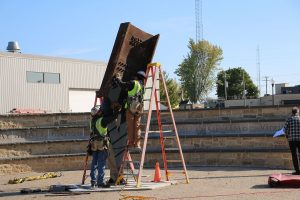 Installers putting beam in final position